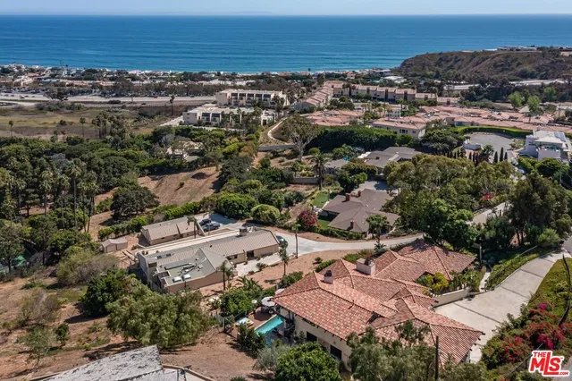 an aerial view of residential building and ocean