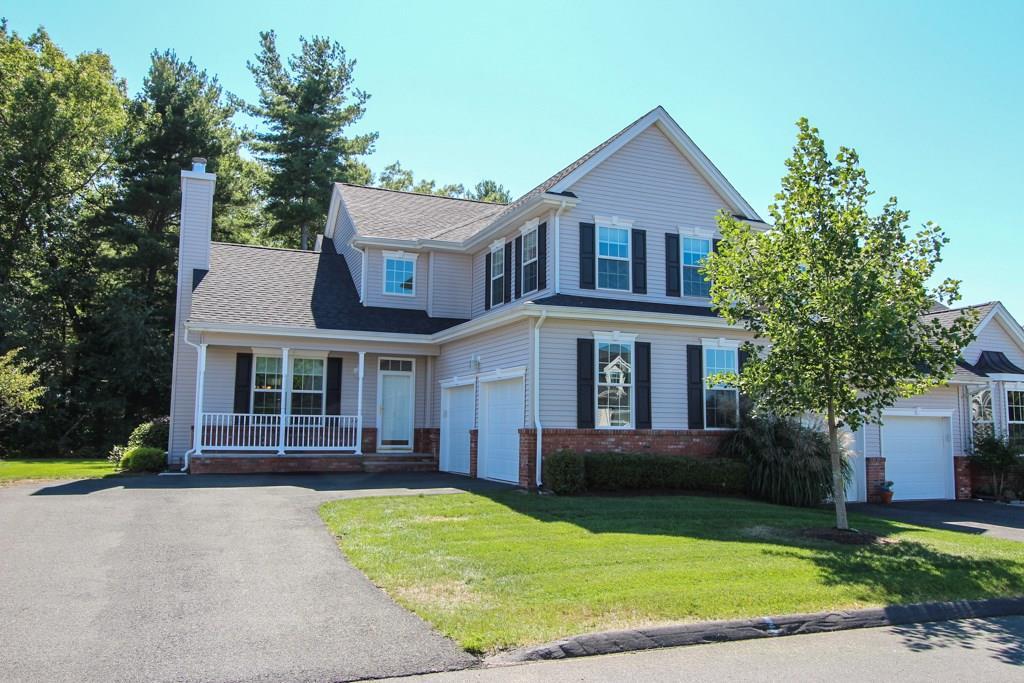 7 Haskins Road, Unit 7 Windsor, CT 06095 - Photo 1 of 1 a front view of a house with a yard and garage