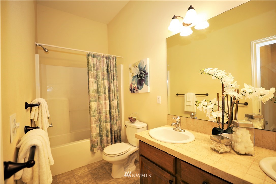 300 Lind Avenue Northwest Renton, WA 98057 - Photo 22 of 25 a bathroom with a sink a toilet and shower