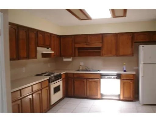 a kitchen with stainless steel appliances granite countertop a stove a sink dishwasher and a refrigerator
