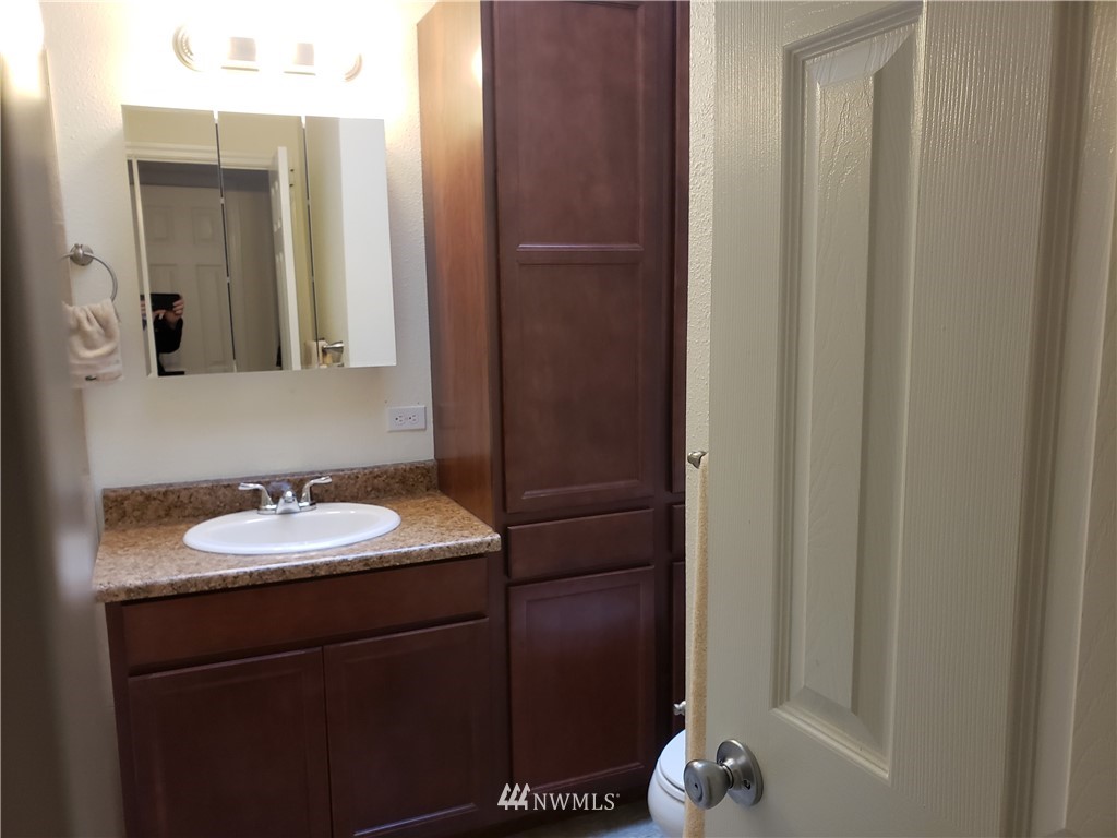 7510 208th Street Southwest, Unit B202 Edmonds, WA 98026 - Photo 8 of 13 a bathroom with a sink and a mirror
