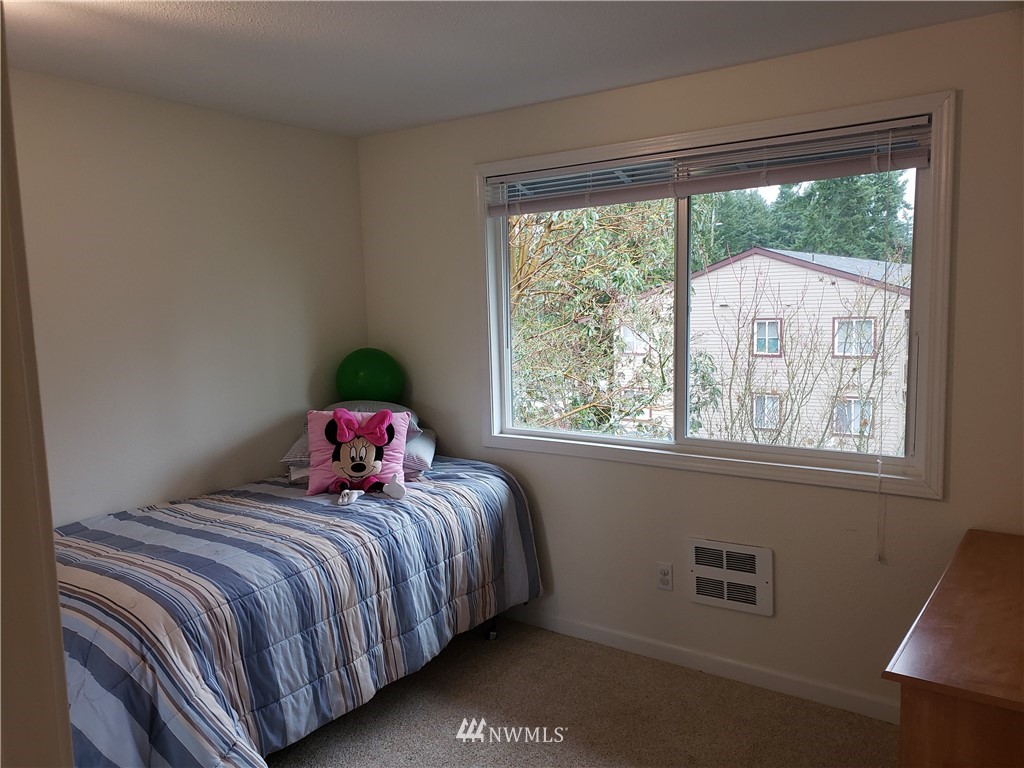 7510 208th Street Southwest, Unit B202 Edmonds, WA 98026 - Photo 10 of 13 a bedroom with a bed and window