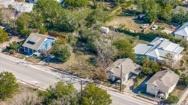 an aerial view of multiple houses with yard