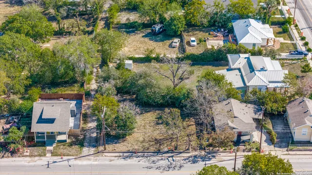 an aerial view of a house with a yard and lake view