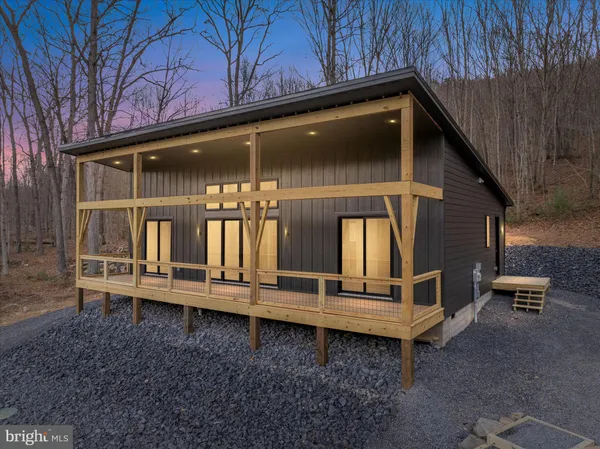 a backyard of a house with outdoor seating