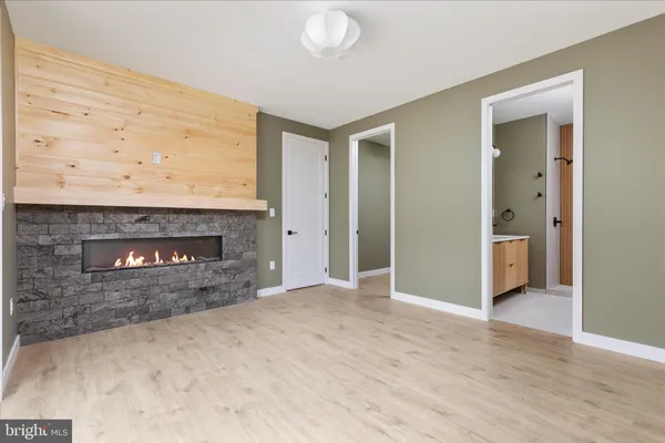 a view of empty room with a fireplace