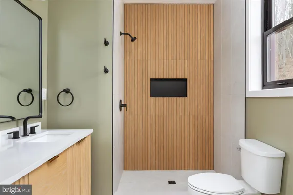 a bathroom with a sink toilet and shower