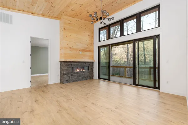 a view of an empty room with a fireplace