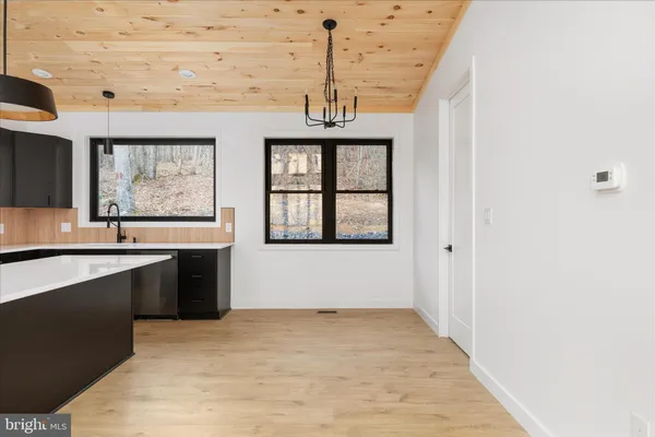 a view of a kitchen with a sink and window