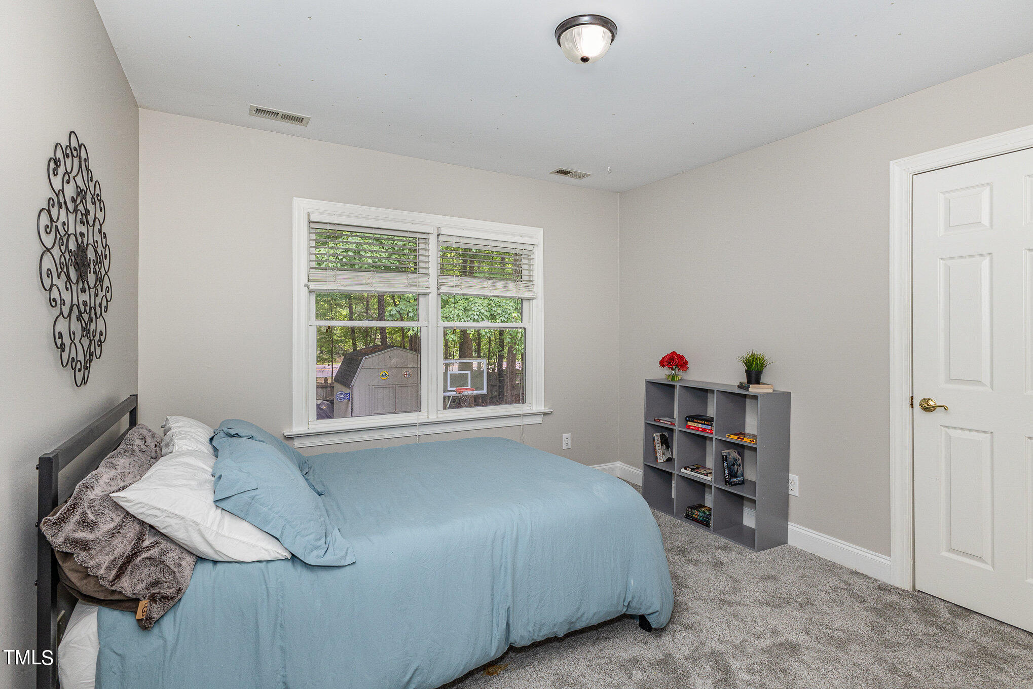 3200 Nimich Pond Way Raleigh, NC 27613 - Photo 18 of 26 a bed sitting in a bedroom next to a window