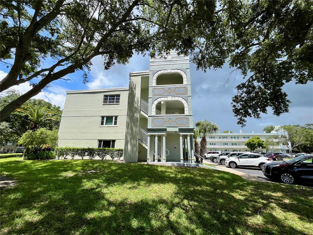 2292 Costa Rican Drive, Unit 22 Clearwater, FL 33763 - Photo 2 of 44 a front view of a house with a yard