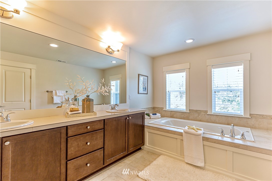 4521 185th Place Southeast Bothell, WA 98012 - Photo 14 of 33 a bathroom with a sink double vanity mirror and a bathtub