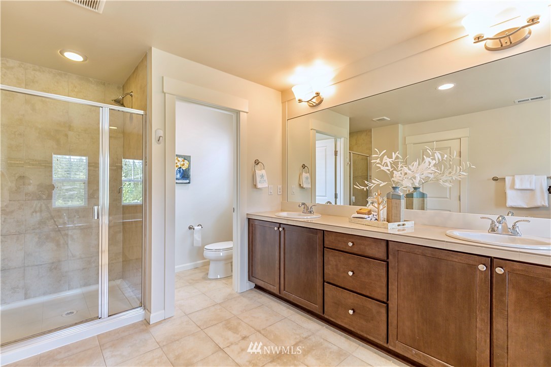 4521 185th Place Southeast Bothell, WA 98012 - Photo 15 of 33 a bathroom with a double vanity sink toilet and shower