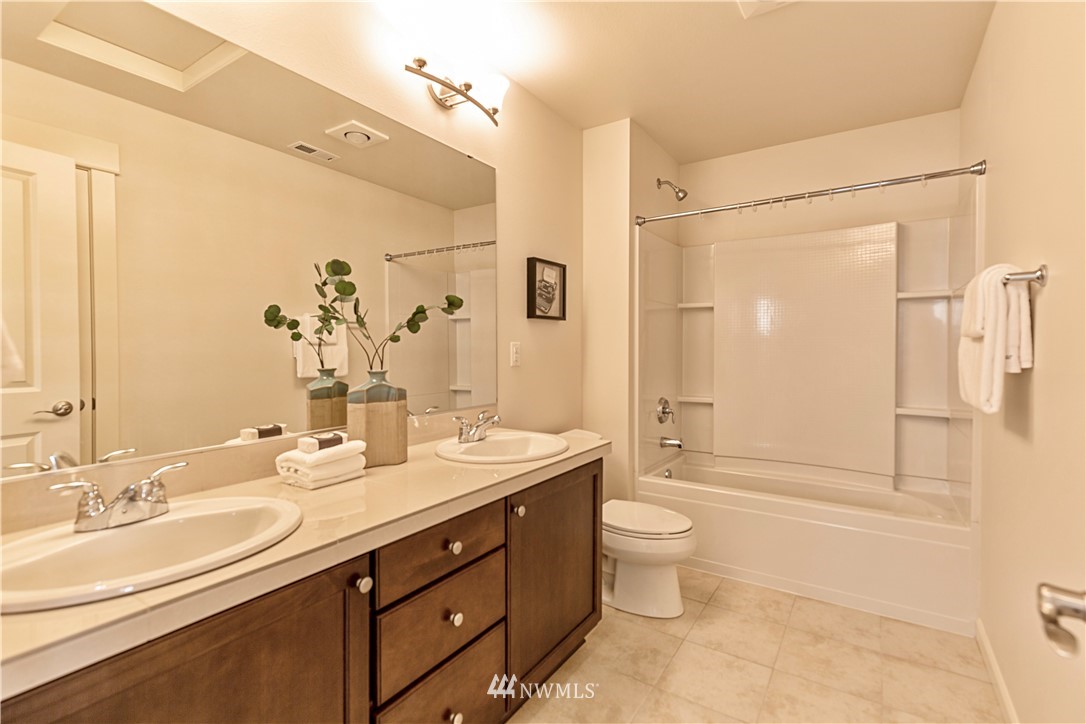 4521 185th Place Southeast Bothell, WA 98012 - Photo 19 of 33 a bathroom with a double vanity sink toilet mirror and shower