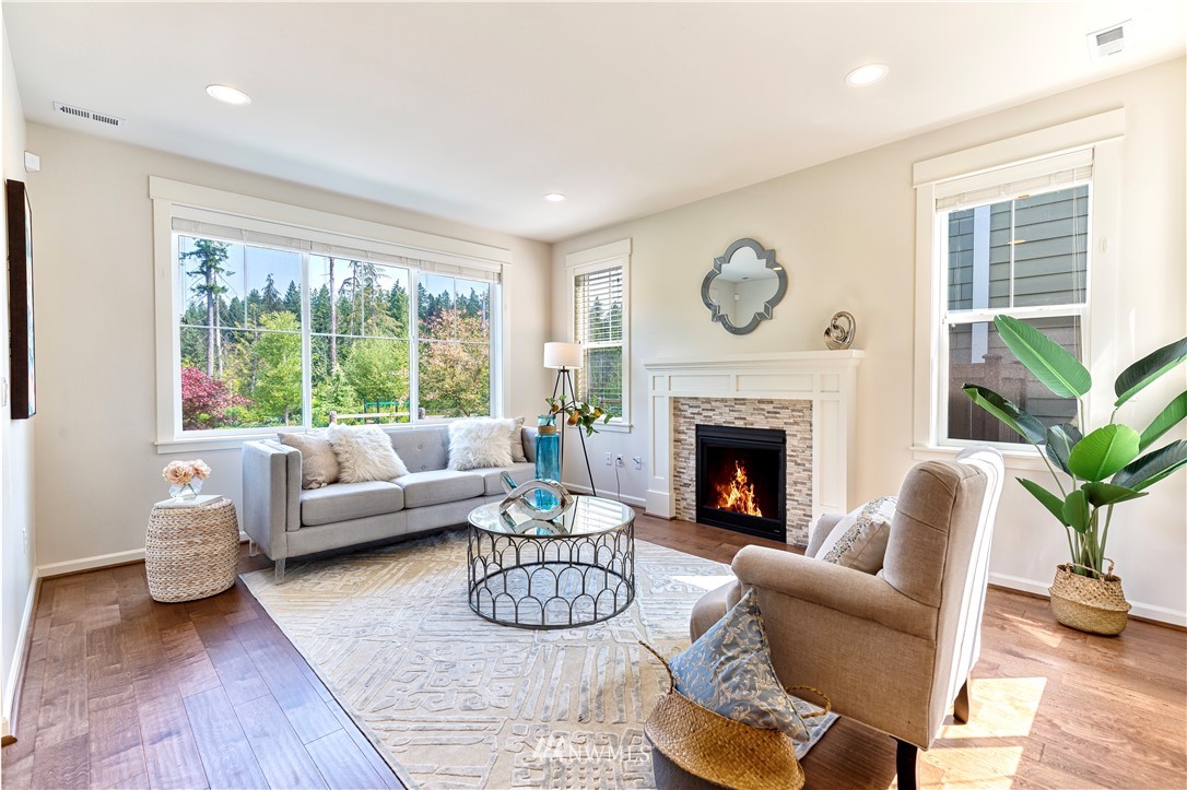 4521 185th Place Southeast Bothell, WA 98012 - Photo 5 of 33 a living room with furniture a fireplace and a large window