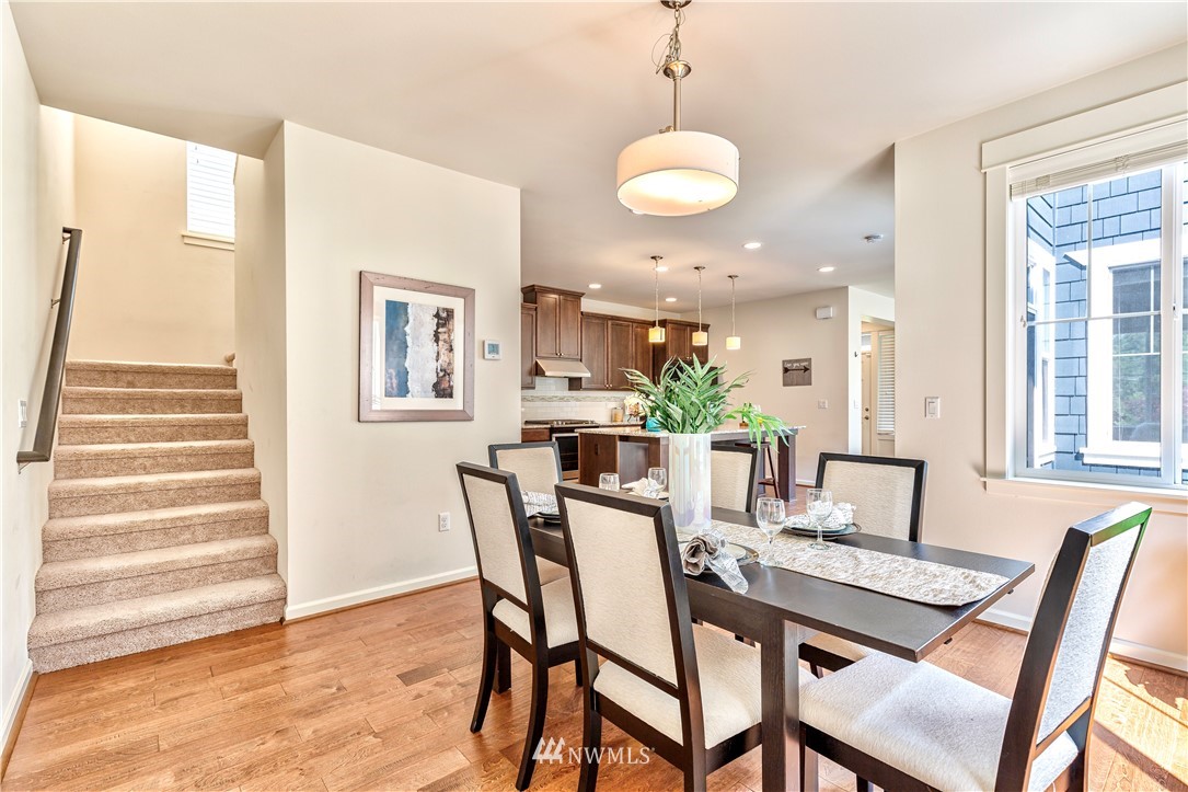 4521 185th Place Southeast Bothell, WA 98012 - Photo 10 of 33 a view of a dining room with furniture and wooden floor