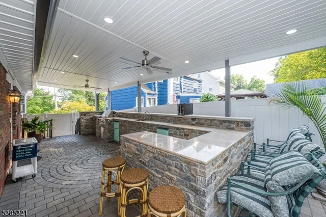 a view of a patio with couches table and chairs and potted plants