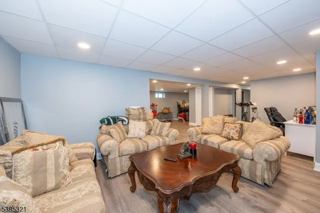 a large white kitchen with a large window and stainless steel appliances