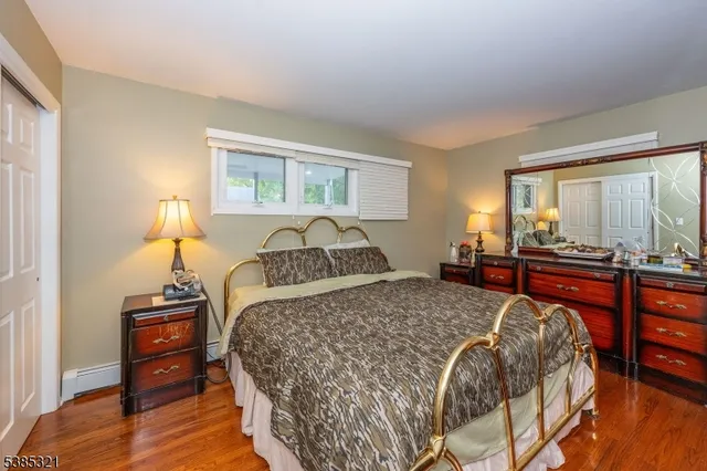 a bedroom with a bed and a television