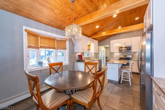 a large kitchen with kitchen island a large counter space a sink and appliances