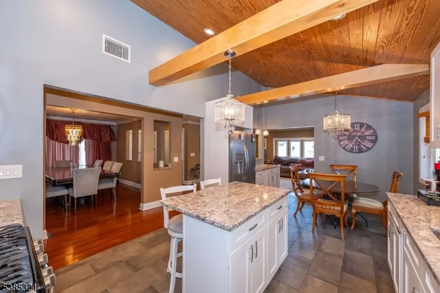 a kitchen with a stove a sink and chairs