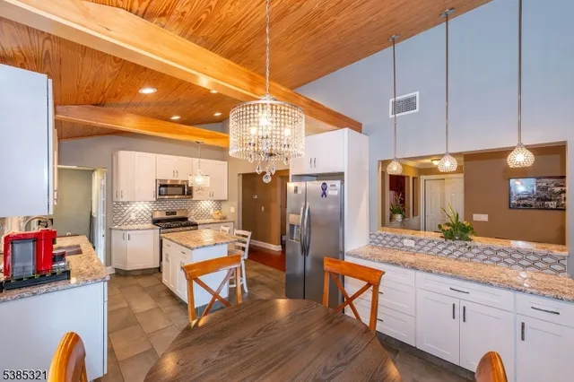 a living room with furniture pool table and a large window