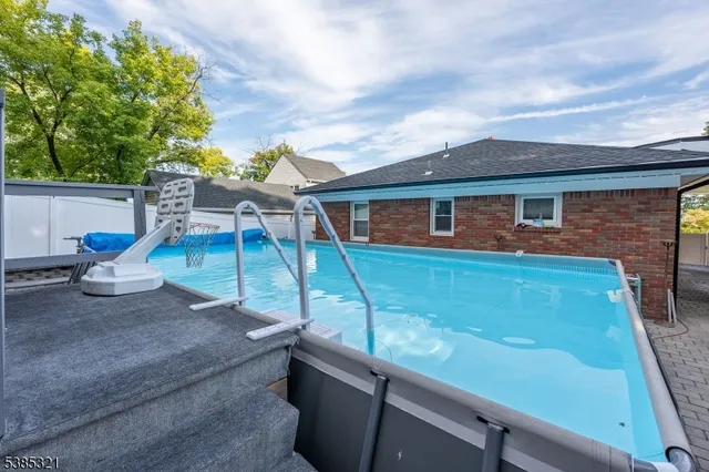 a view of a patio with couches chairs and wooden floor