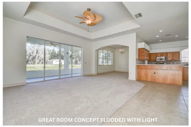 a kitchen with stainless steel appliances granite countertop a refrigerator a stove a sink dishwasher and wooden cabinets with wooden floor