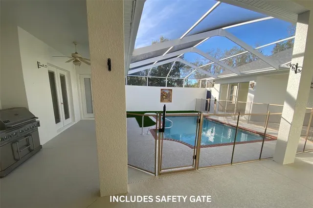 an empty room with chandelier fan and windows