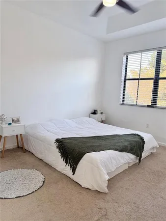 a bedroom with a bed and window