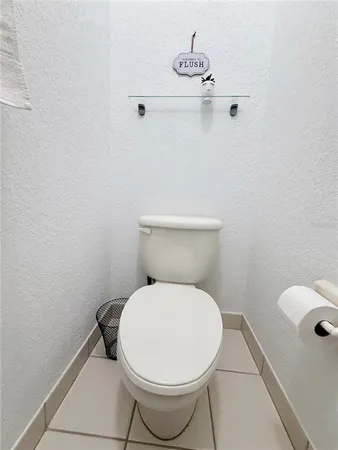 a white toilet sitting next to a bathroom sink