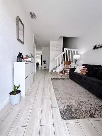a living room with furniture and a potted plant