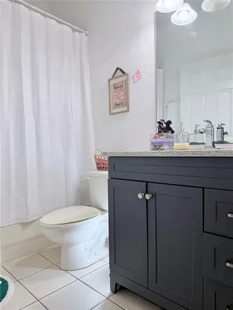 a bathroom with a toilet a sink and a mirror