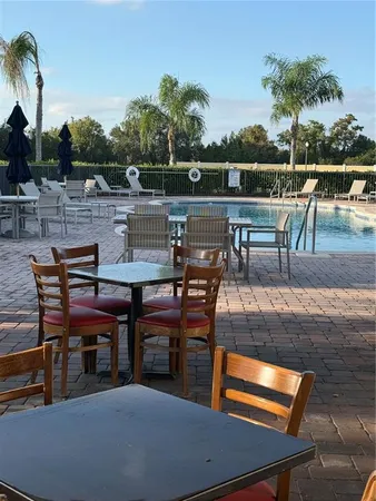 a living room with furniture and floor to ceiling window