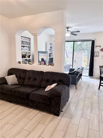 a living room with furniture and large windows