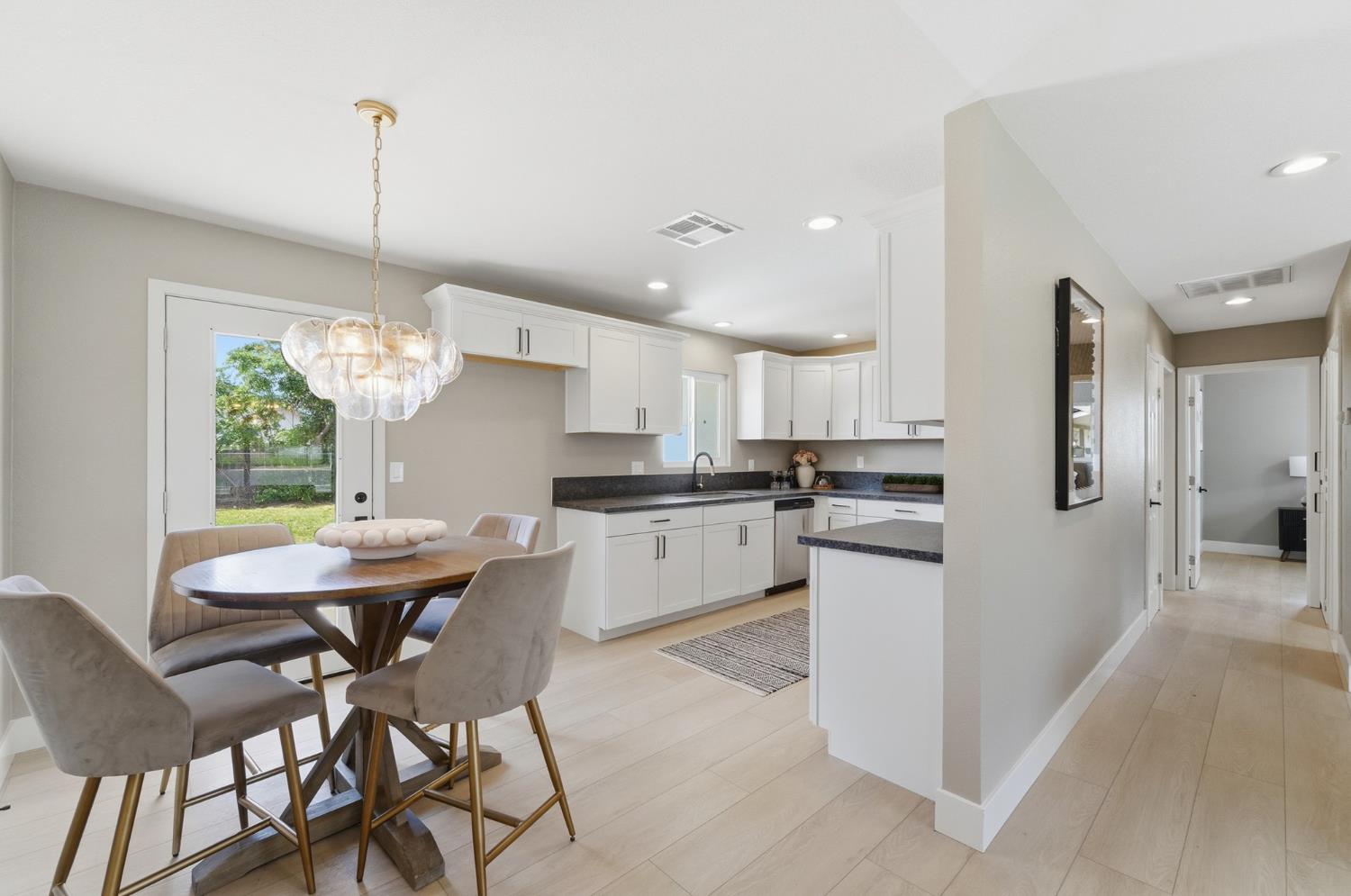 6237 Claus Road Riverbank, CA 95367 - Photo 12 of 53 a kitchen with white cabinets and stainless steel appliances
