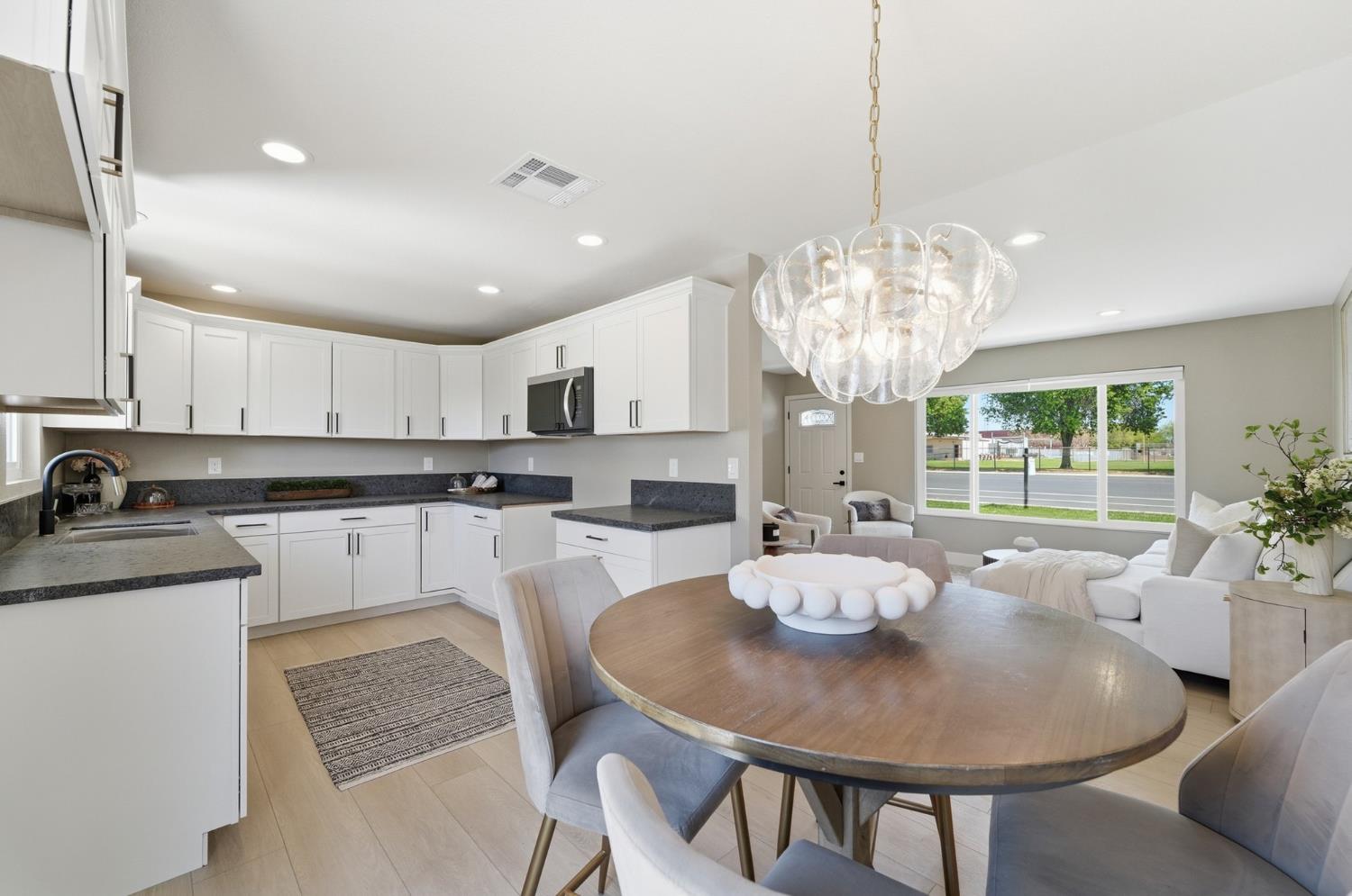6237 Claus Road Riverbank, CA 95367 - Photo 14 of 53 a large kitchen with kitchen island a dining table and chairs