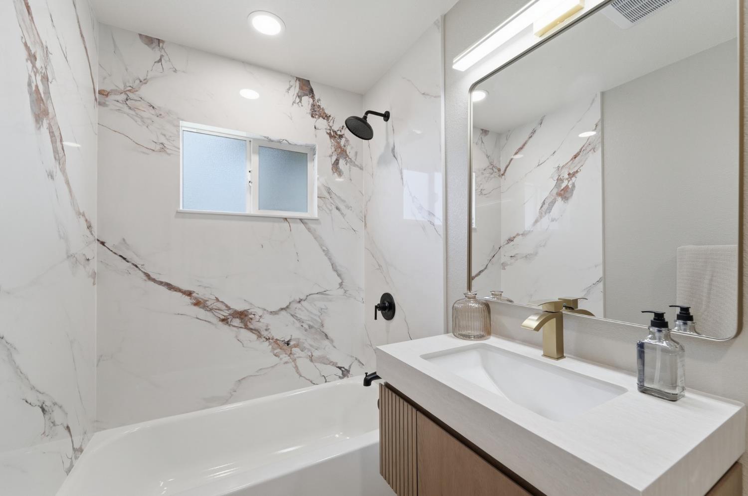 6237 Claus Road Riverbank, CA 95367 - Photo 20 of 53 a bathroom with a sink a mirror and a shower