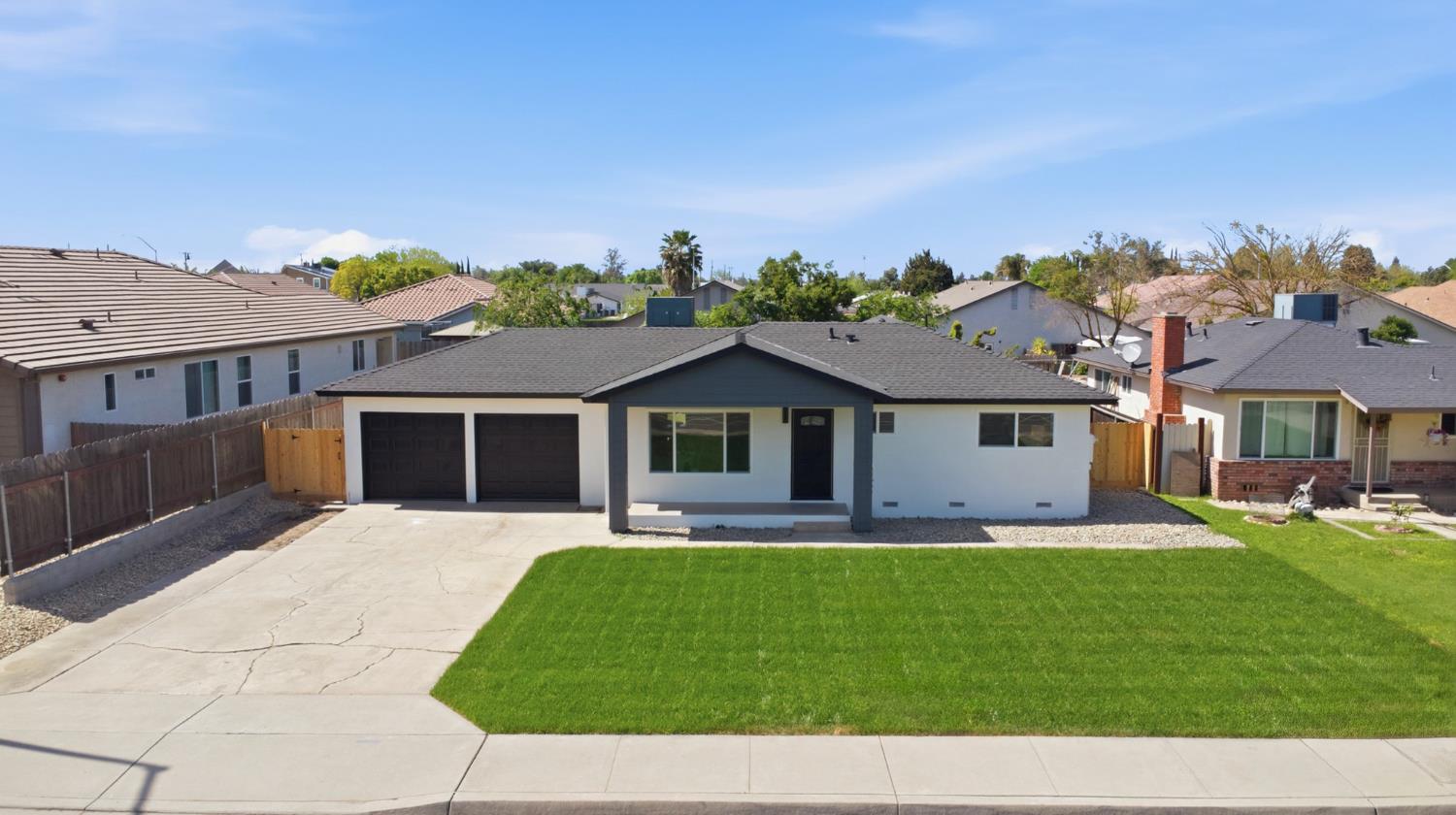 6237 Claus Road Riverbank, CA 95367 - Photo 2 of 53 a front view of a house with a yard and garage