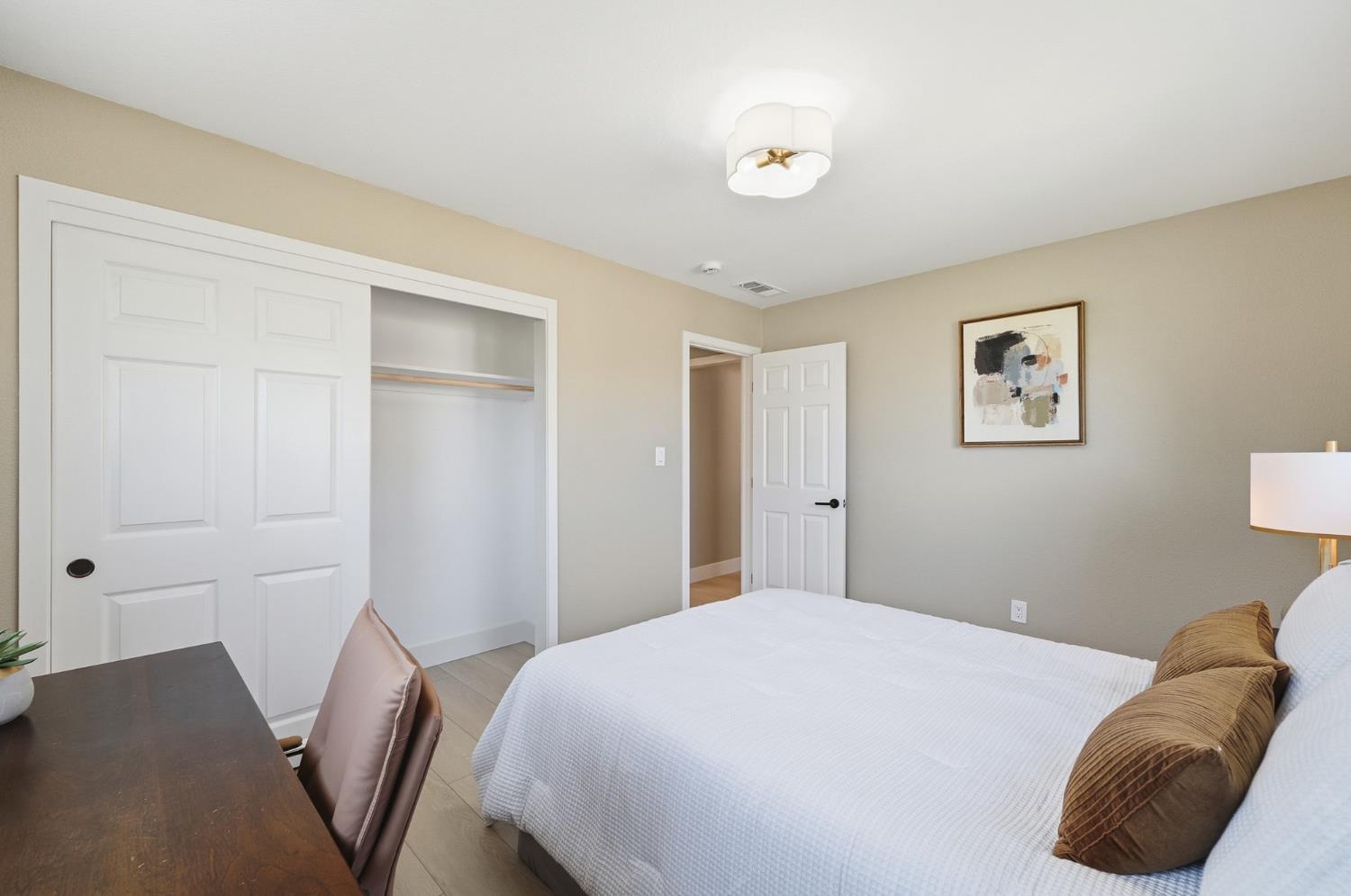 6237 Claus Road Riverbank, CA 95367 - Photo 22 of 53 a bedroom with a bed and a painting on the wall