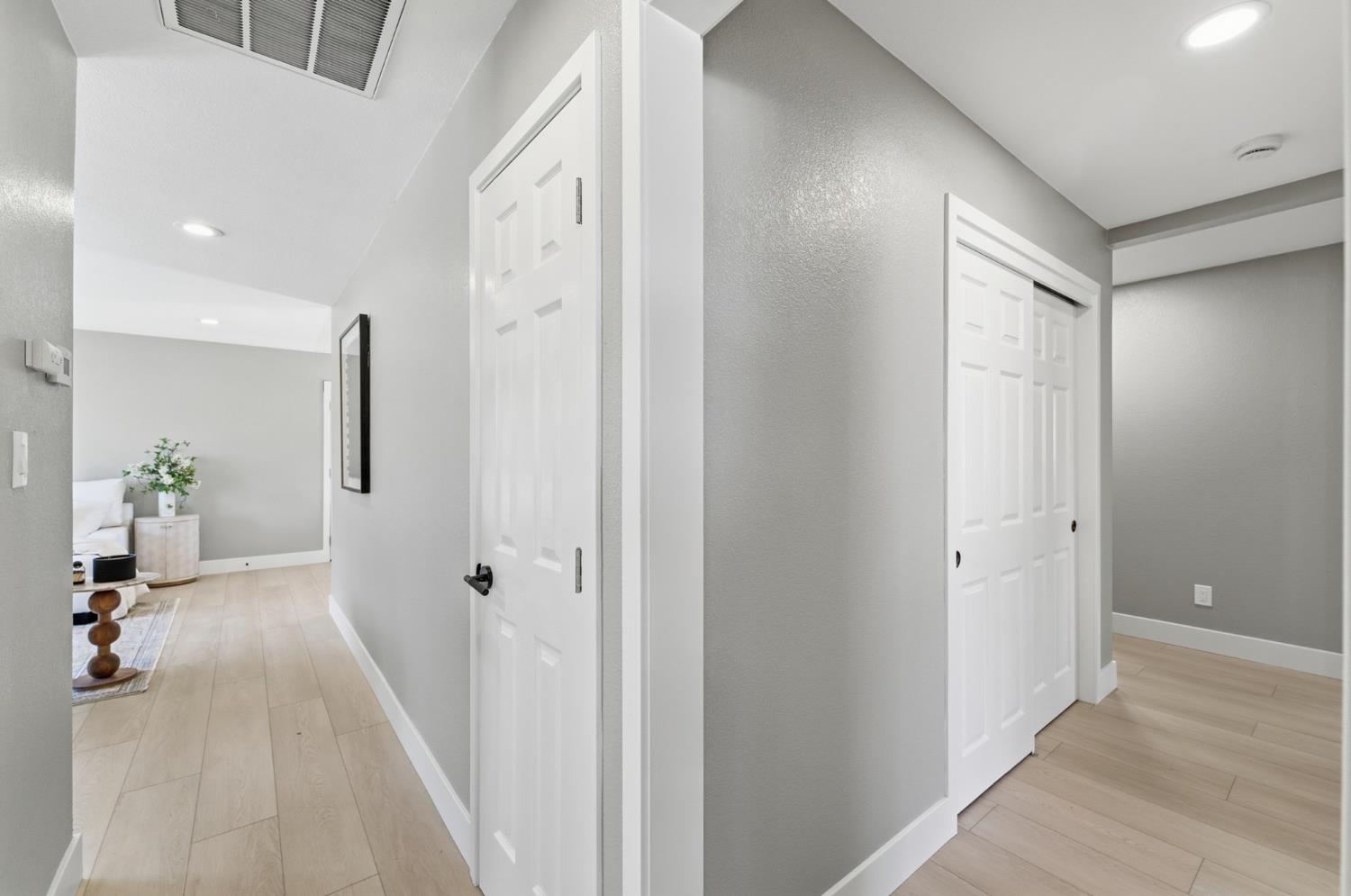 6237 Claus Road Riverbank, CA 95367 - Photo 23 of 53 a view of a hallway with wooden floor and a bathroom