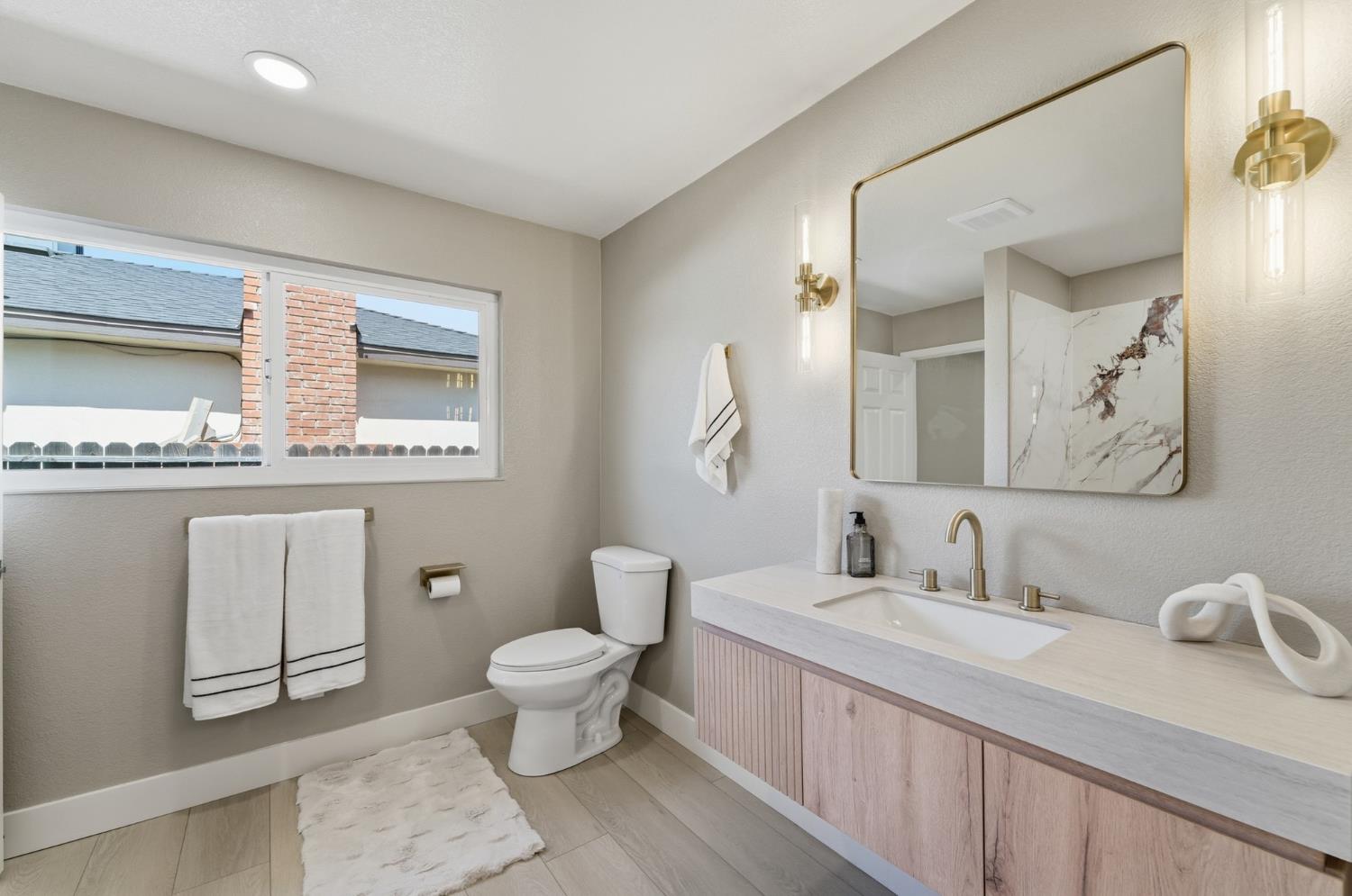 6237 Claus Road Riverbank, CA 95367 - Photo 24 of 53 a bathroom with a granite countertop toilet sink and mirror