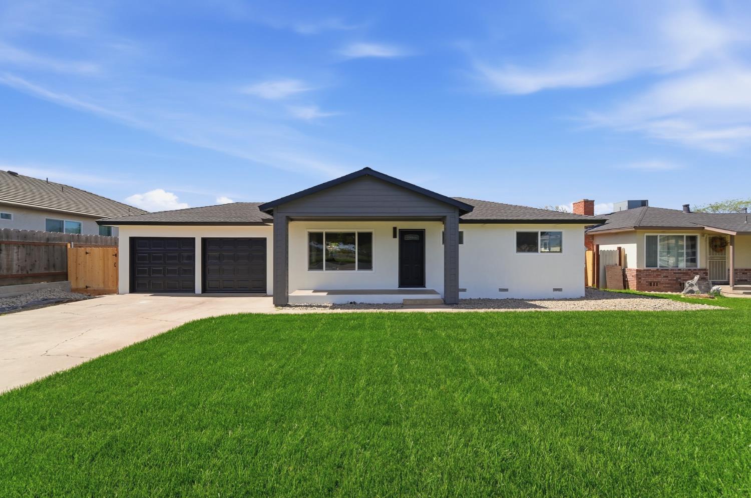 6237 Claus Road Riverbank, CA 95367 - Photo 3 of 53 a front view of a house with a garden and yard