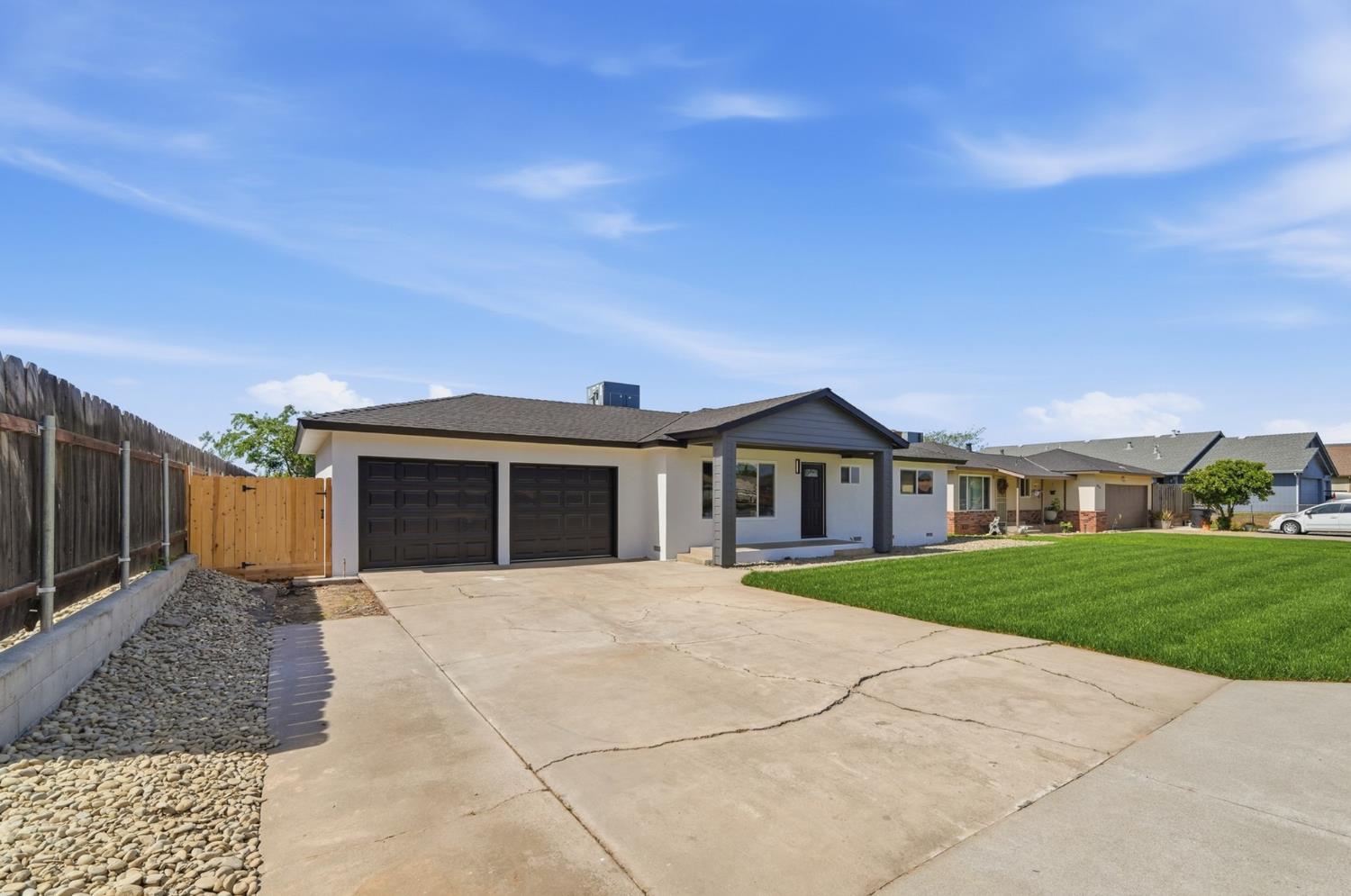 6237 Claus Road Riverbank, CA 95367 - Photo 4 of 53 a front view of a house with a yard and garage
