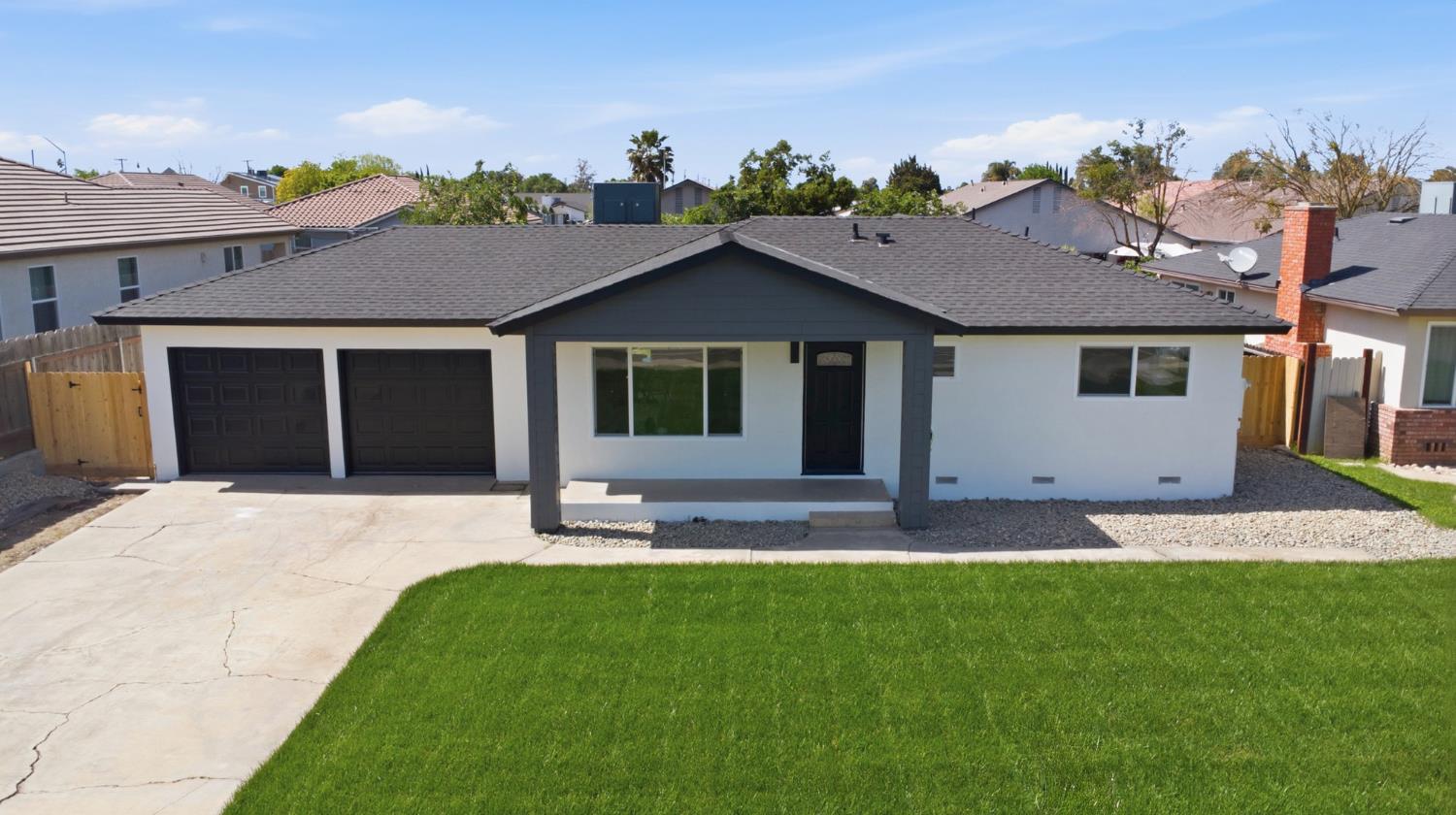 6237 Claus Road Riverbank, CA 95367 - Photo 46 of 53 a front view of a house with a yard and garage