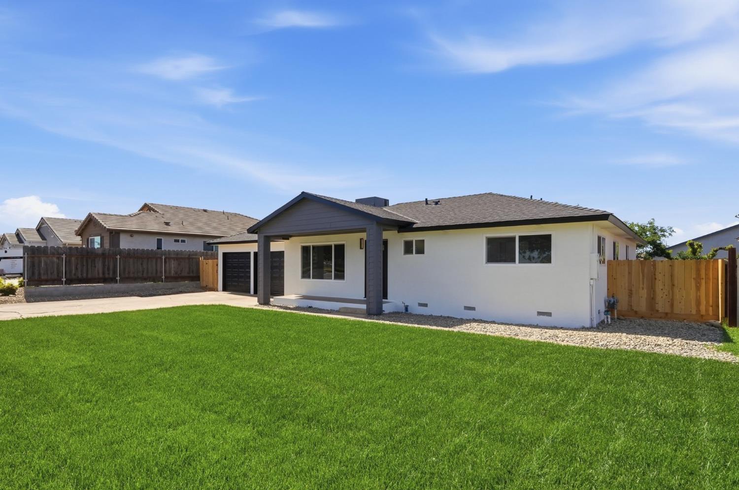 6237 Claus Road Riverbank, CA 95367 - Photo 5 of 53 a front view of a house with a garden and yard