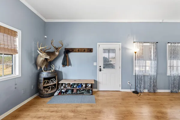 a spacious bedroom with a large bed and a chandelier fan