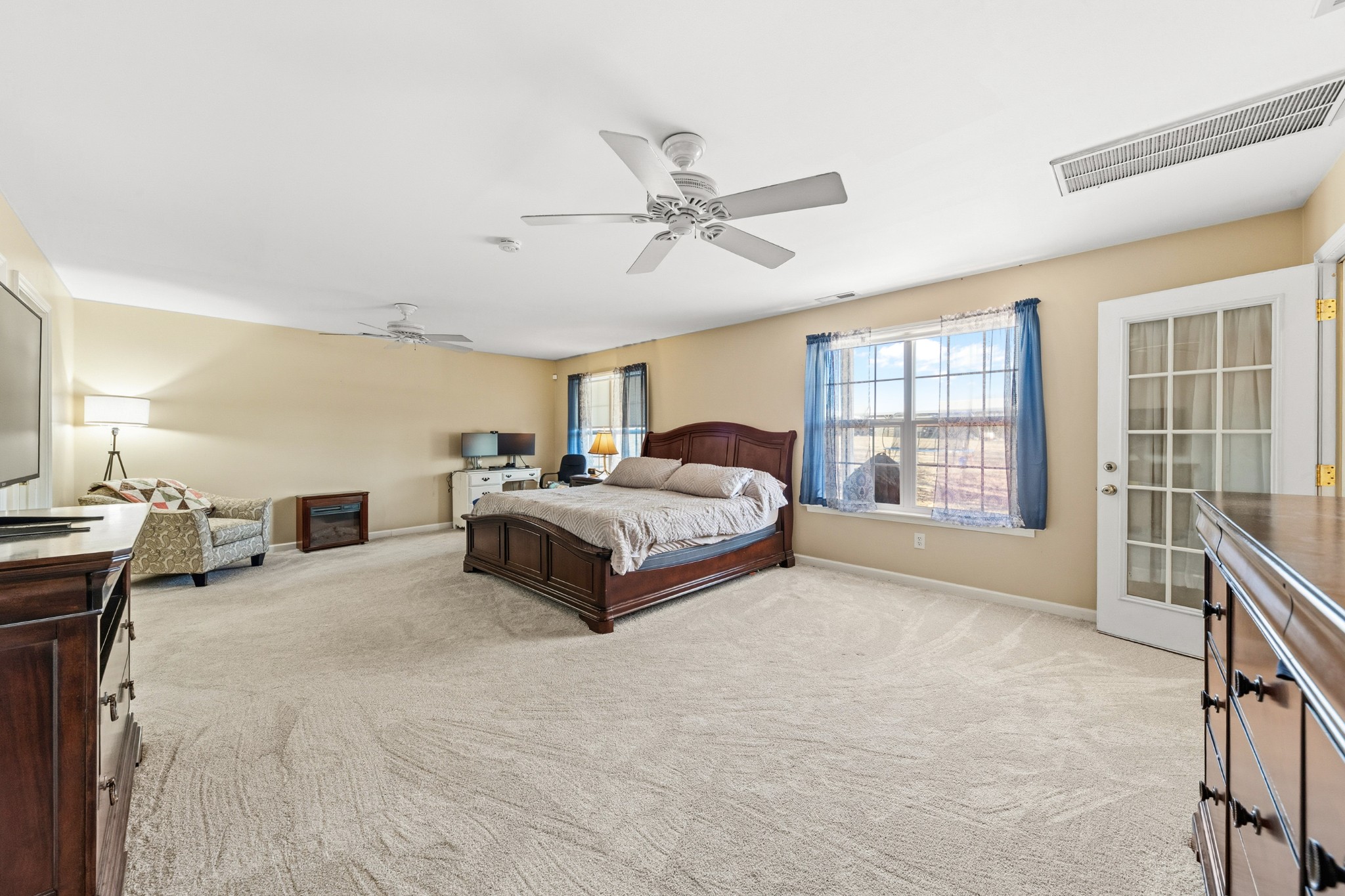 1825 Powell School Road Goodspring, TN 38460 - Photo 34 of 100 a spacious bedroom with a large bed and a chandelier fan