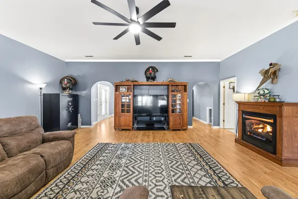 a living room with furniture and a chandelier