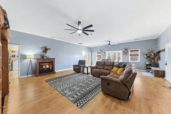 a kitchen with stainless steel appliances kitchen island granite countertop a stove a sink and white cabinets